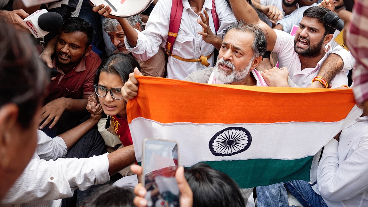 Yogendra Yadav (with flag), Neha Bora (L), and others at the Jantar Mantar protest against Gyanesh Kumar