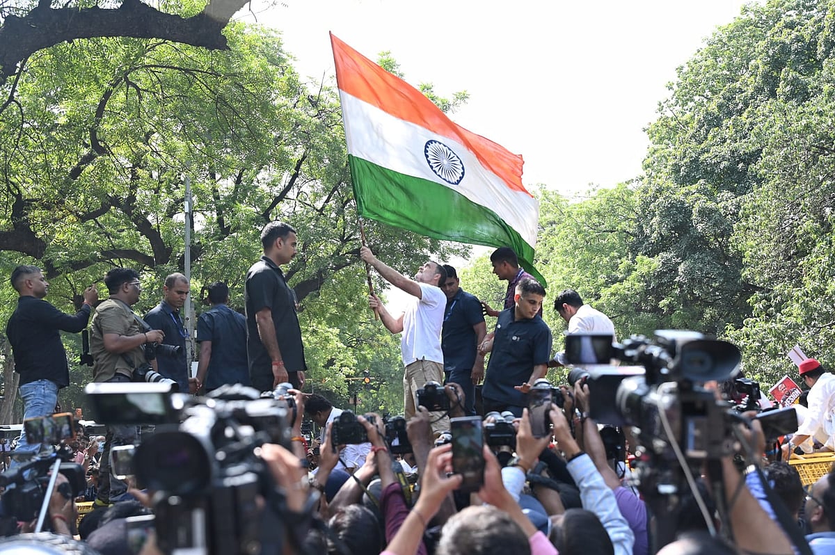 Rahul Gandhi climbs atop the barricades during the INDIA bloc MPs' march from Parliament to the ECI. 