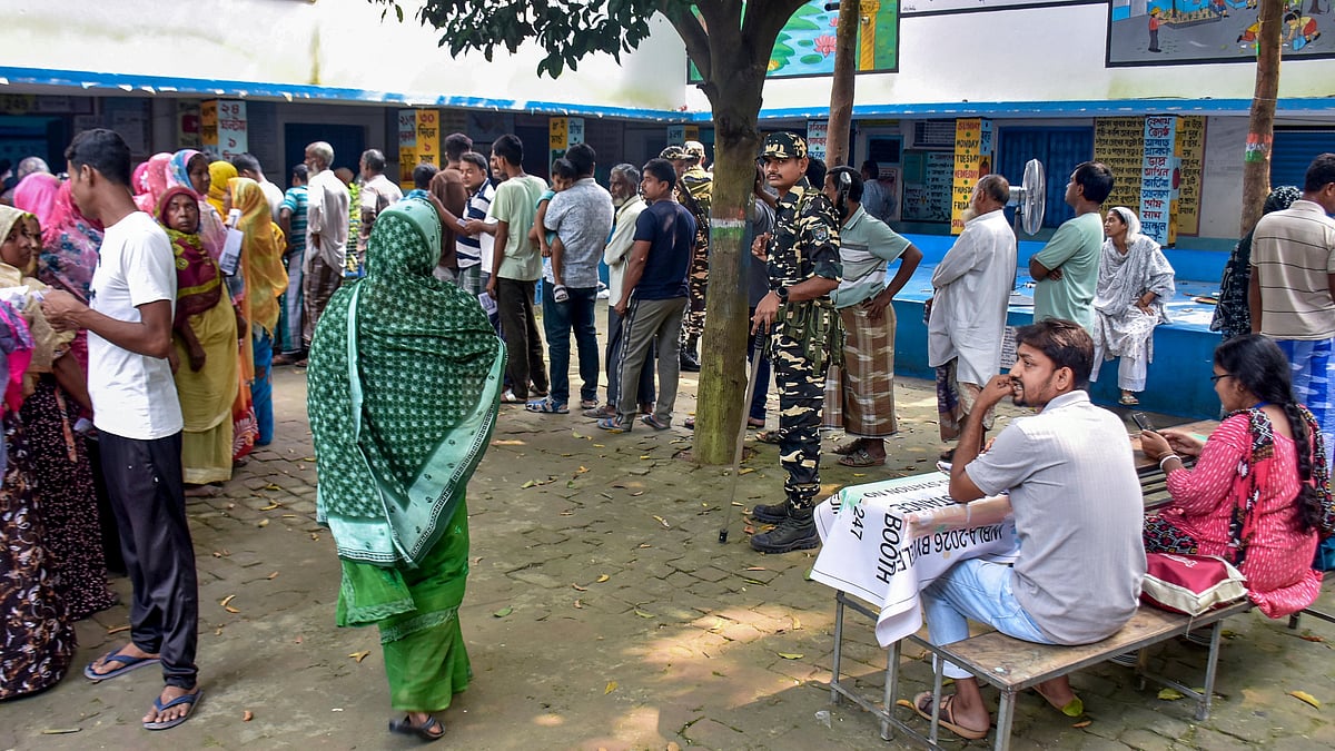 People queue to cast their vote in for the Rejinagar by-poll in Murshidabad