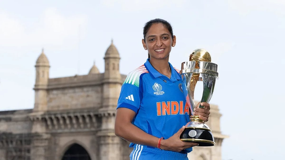 High point: Harmanpreet with ODI World Cup trophy last year