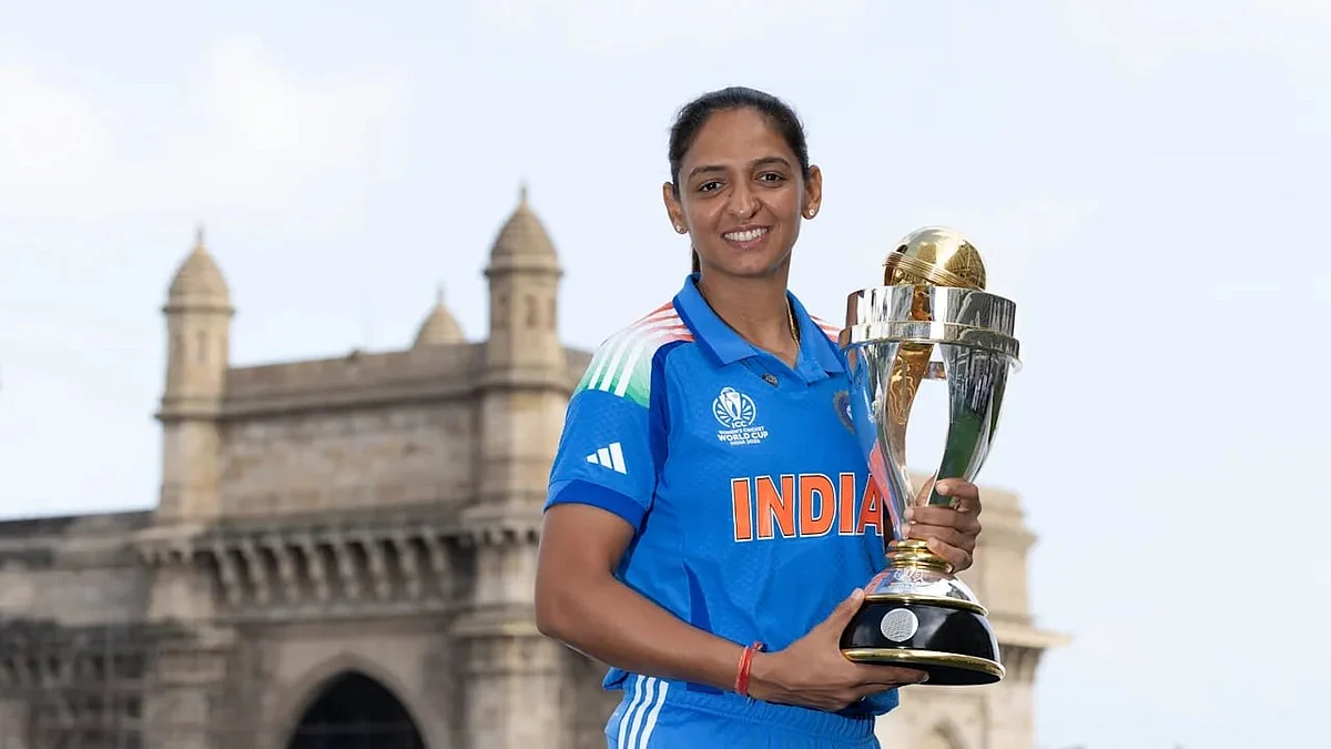 High point: Harmanpreet with ODI World Cup trophy last year
