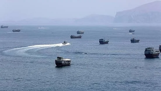 Vessels transit the Strait of Hormuz.