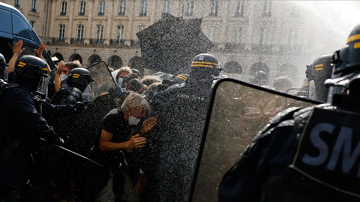 Riot police use a water cannon as they face students during a protest against under-resourced schools. 
