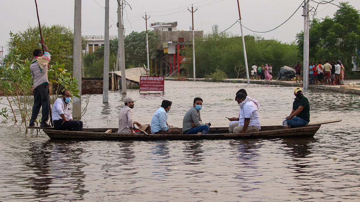 A boat ferries residents through flood-affected areas of Lucknow.