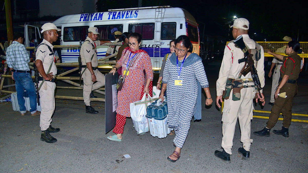 Polling officials transport EVMs to a strong room after voting in Nagaon LS bypoll.