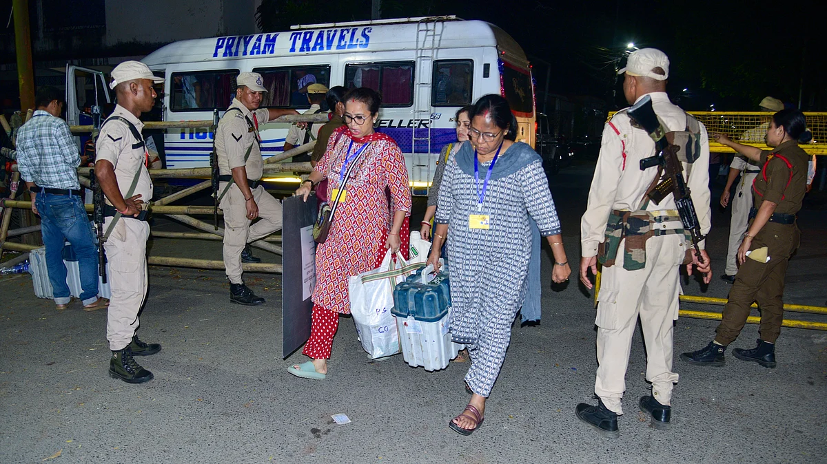 Polling officials transport EVMs to a strong room after voting in Nagaon LS bypoll.