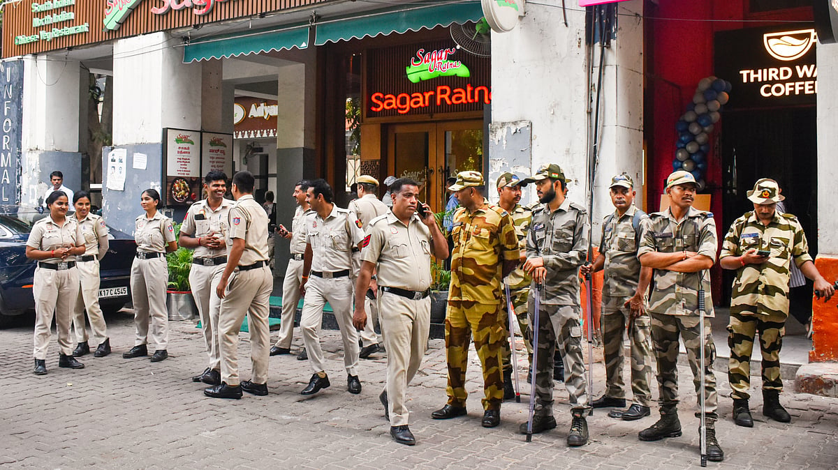 Police and security personnel stand guard at Janpath, New Delhi, 9 Oct