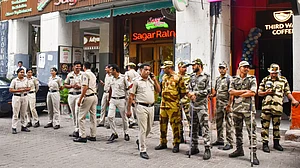 Police and security personnel stand guard at Janpath, New Delhi, 9 Oct