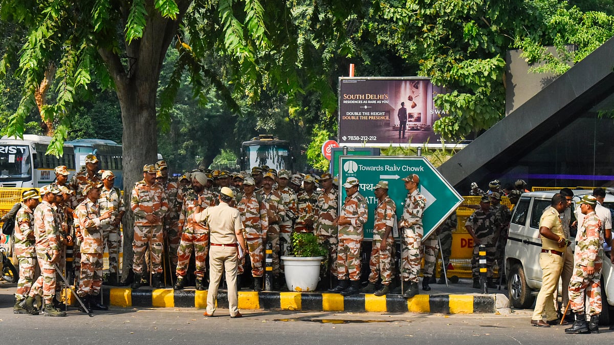 Security personnel stand guard ahead of the INDIA bloc march to Rashtrapati Bhavan at Janpath, 9 Oct