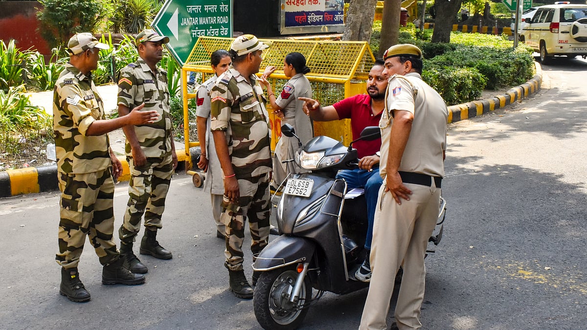 Security personnel check commuters near Jantar Mantar, in New Delhi, 9 Oct
