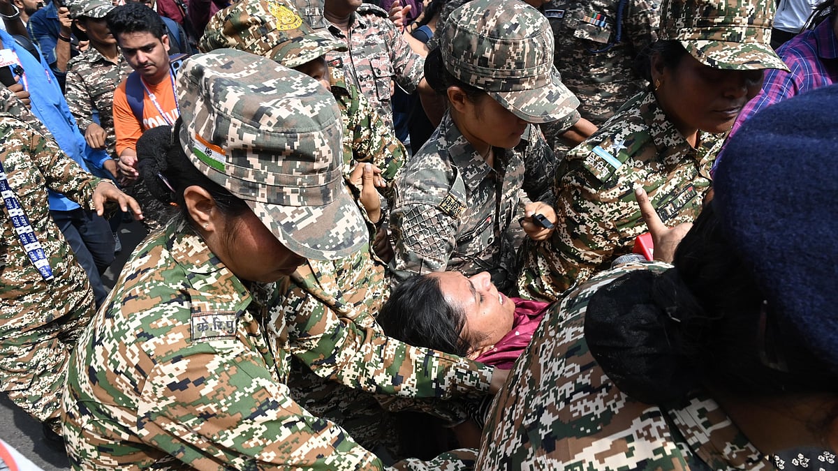 A protester being detained by the police in New Delhi