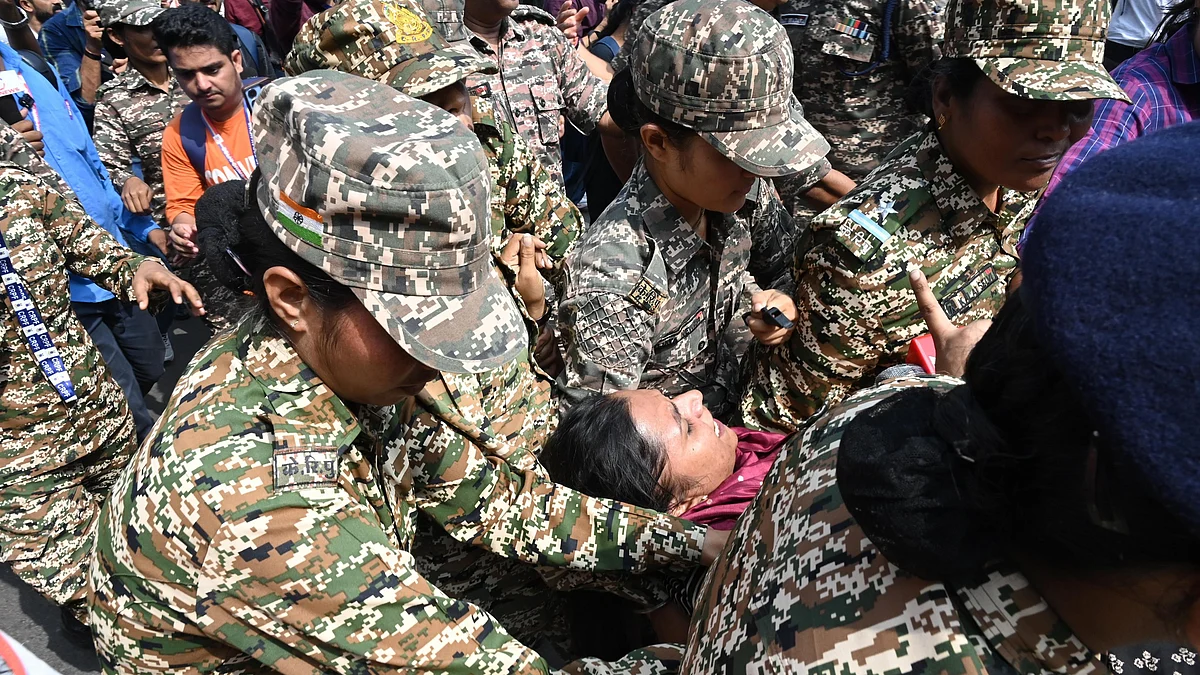 A protester being detained by the police in New Delhi