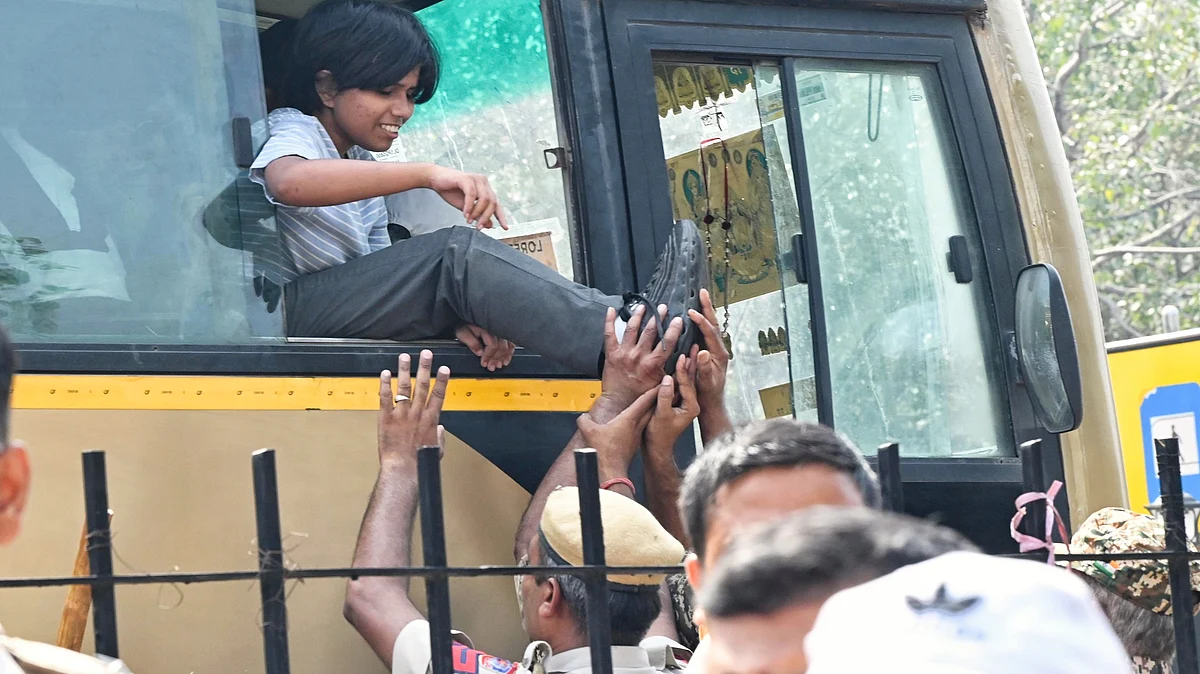 A protester being taken into custody near Bangla Sahib Gurudwara, New Delhi