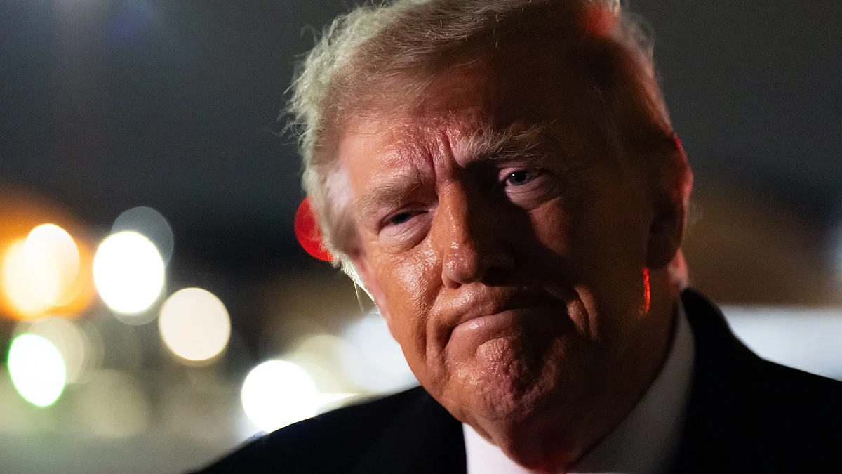 US President Donald Trump speaks to reporters aboard Air Force One.