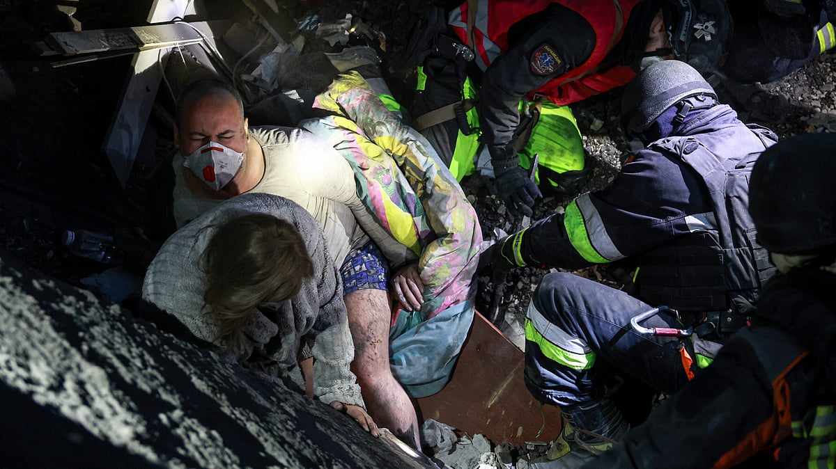Rescuers pull a family from a building destroyed by a Russian airstrike in Zaporizhzhia, Ukraine, 10 Oct