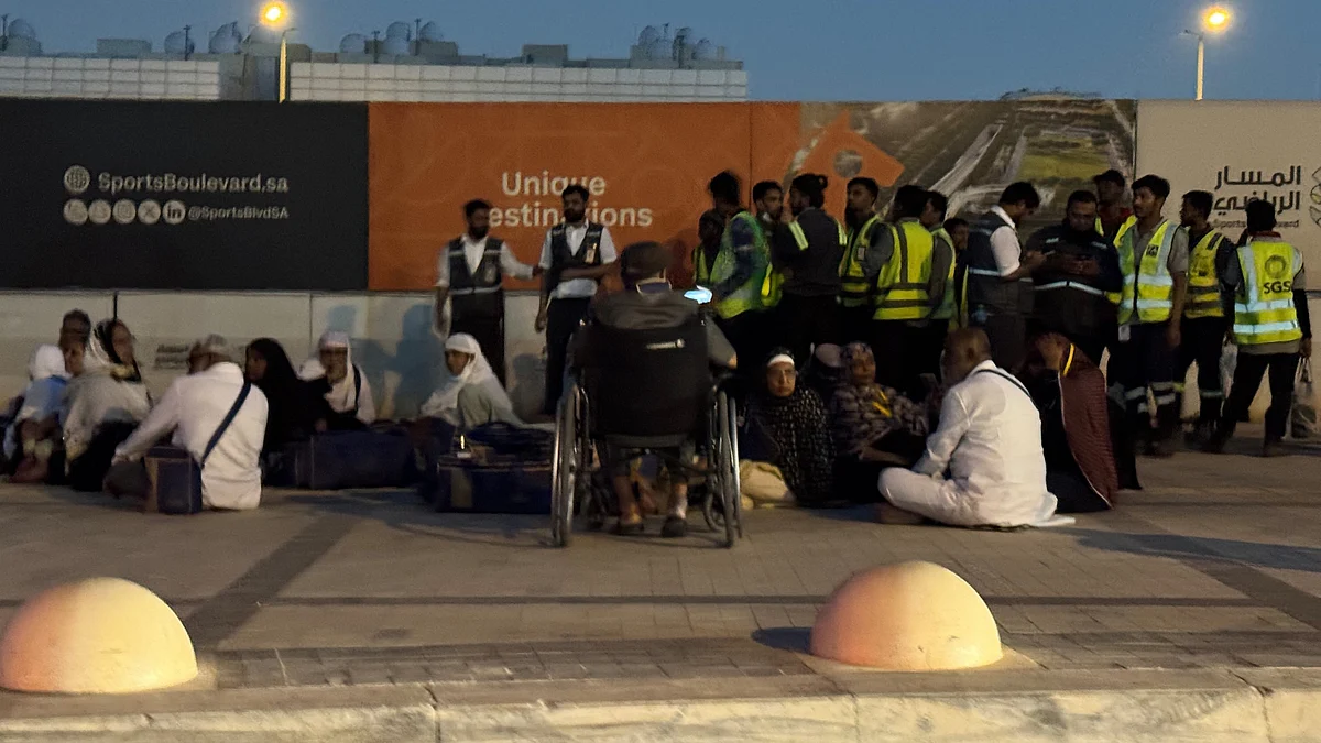 People gather outside a metro station along road to King Khalid International Airport in Riyadh.