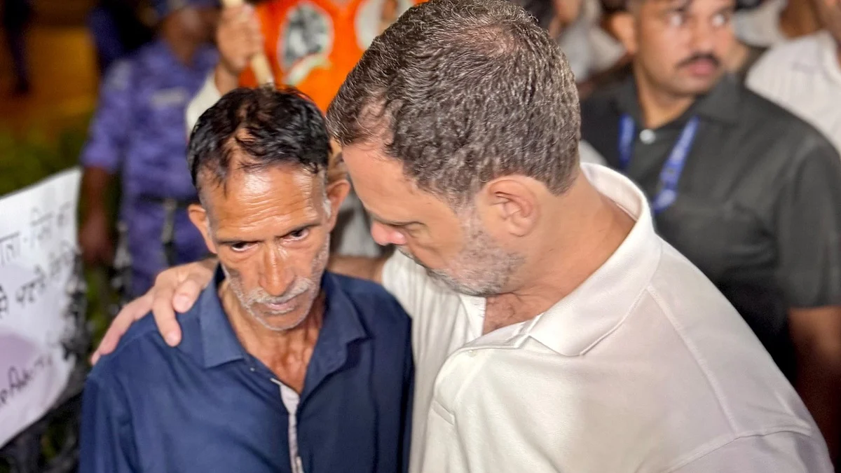 Rahul Gandhi meets Ankita Bhandari’s father during a sit-in protest at India Gate in New Delhi.