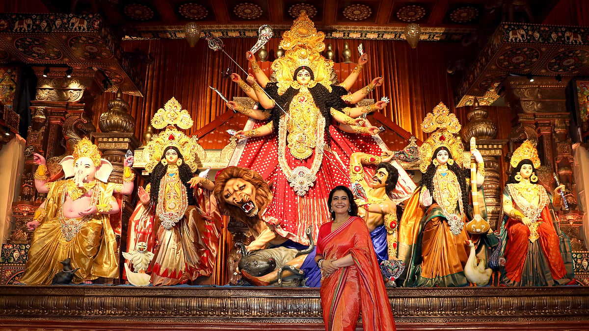 Bollywood actor Kajol poses for photographs during 80th North Bombay Durga Puja festival.