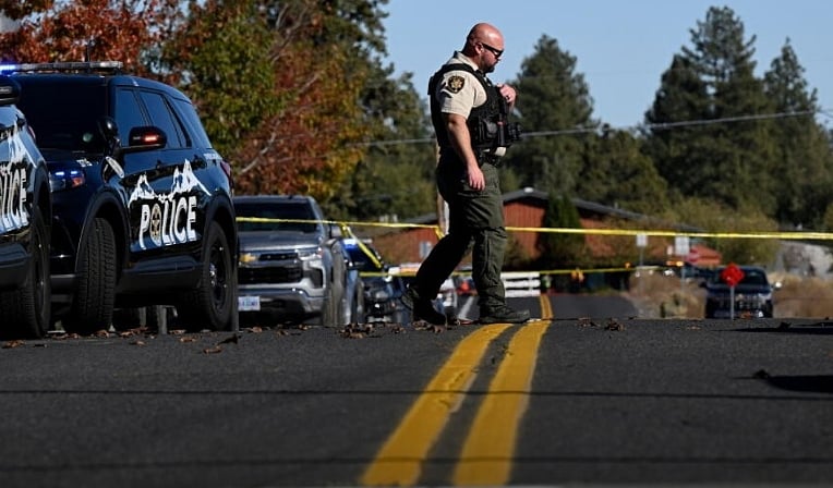 Armed with a long gun, the teenager shot through locked doors to enter the school.