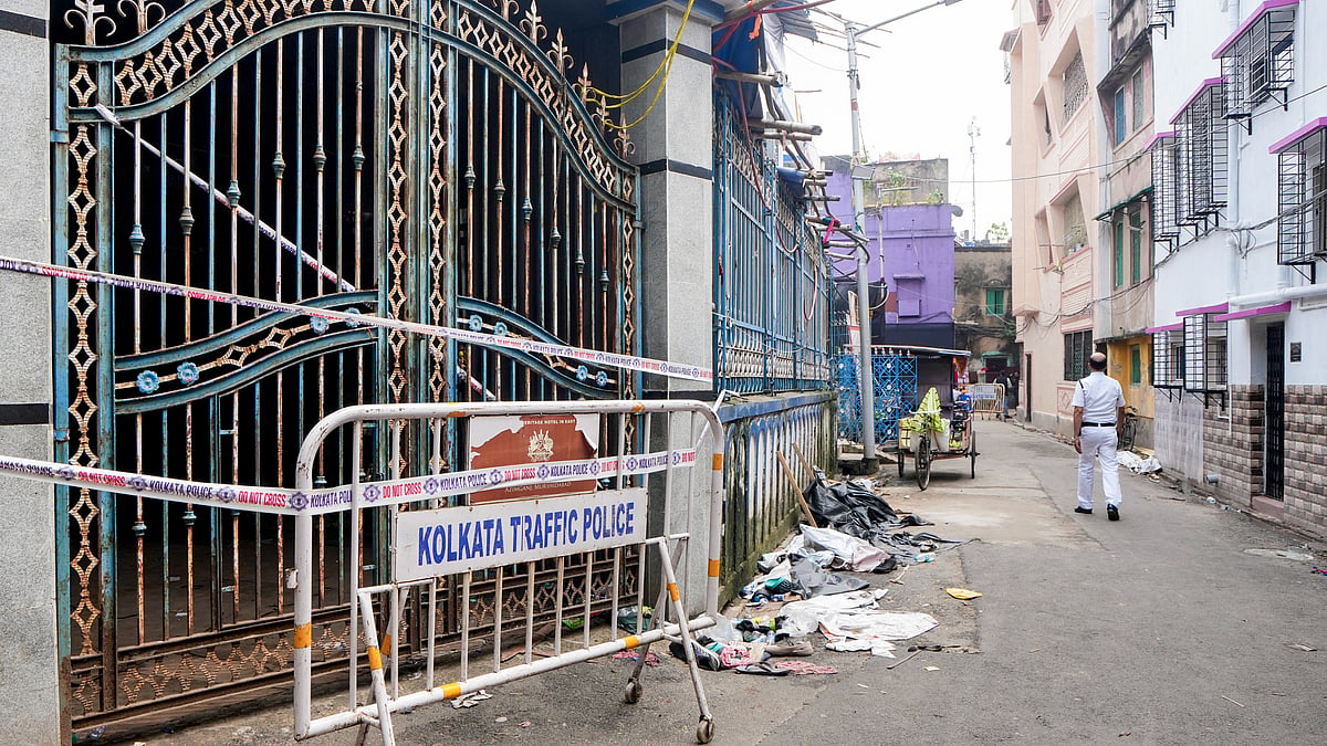 A police official walks past the sealed Chorbagan Sarbojanin Durga Puja pandal following a stampede