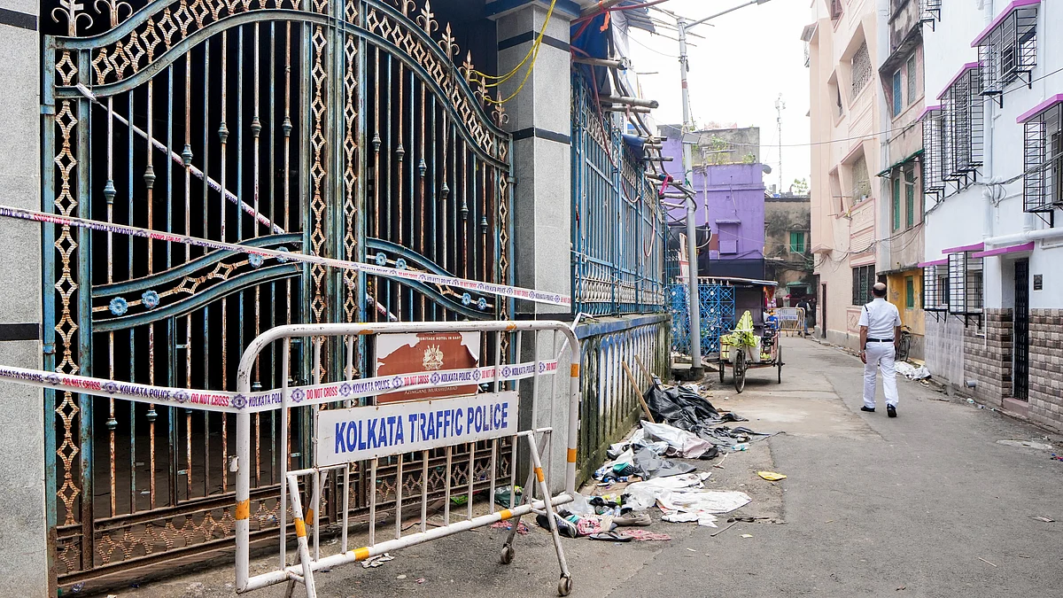 A police official walks past the sealed Chorbagan Sarbojanin Durga Puja pandal following a stampede