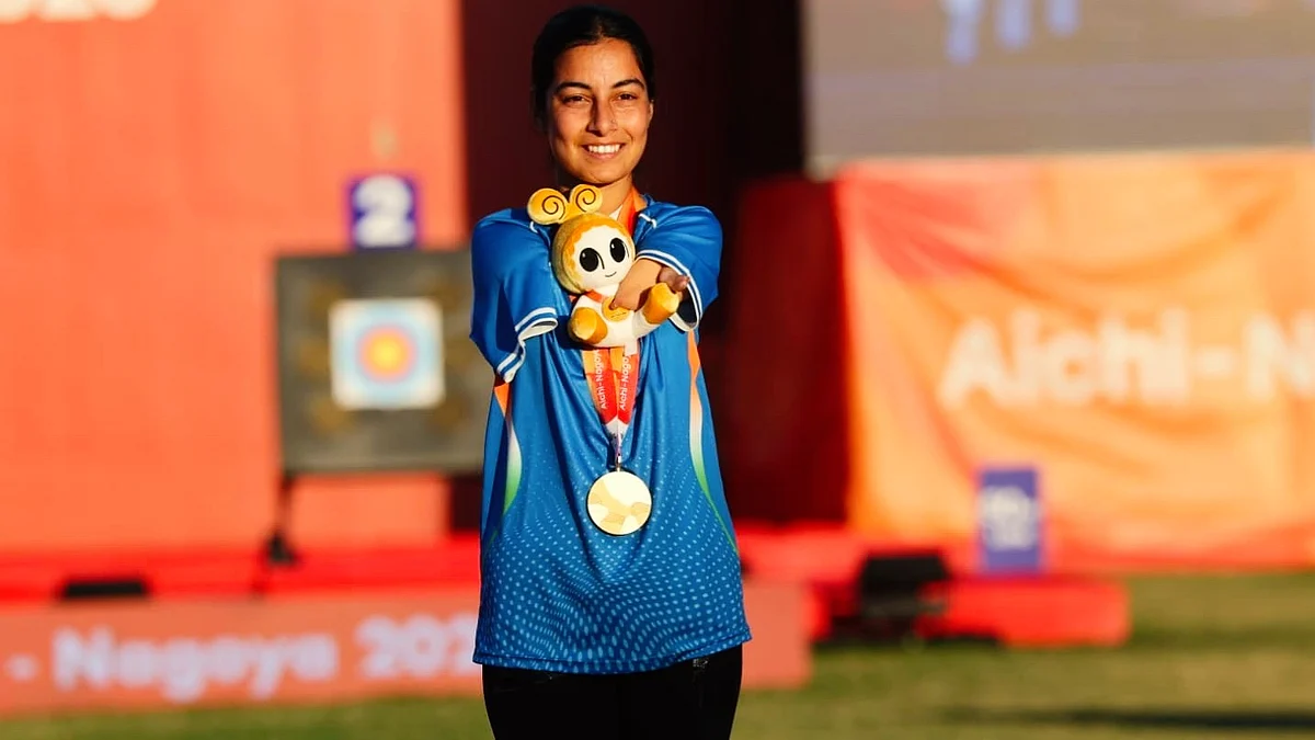 Golden girl: Sheetal Devi flashes one of her two gold medals on the podium