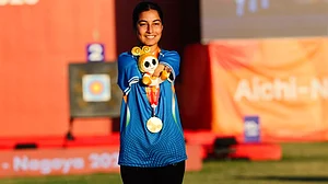 Golden girl: Sheetal Devi flashes one of her two gold medals on the podium