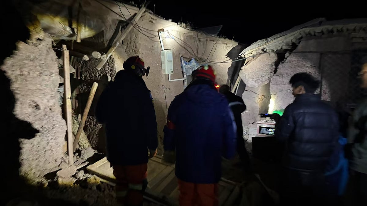 Firefighters assess damage in a village struck by an earthquake in Tibet.