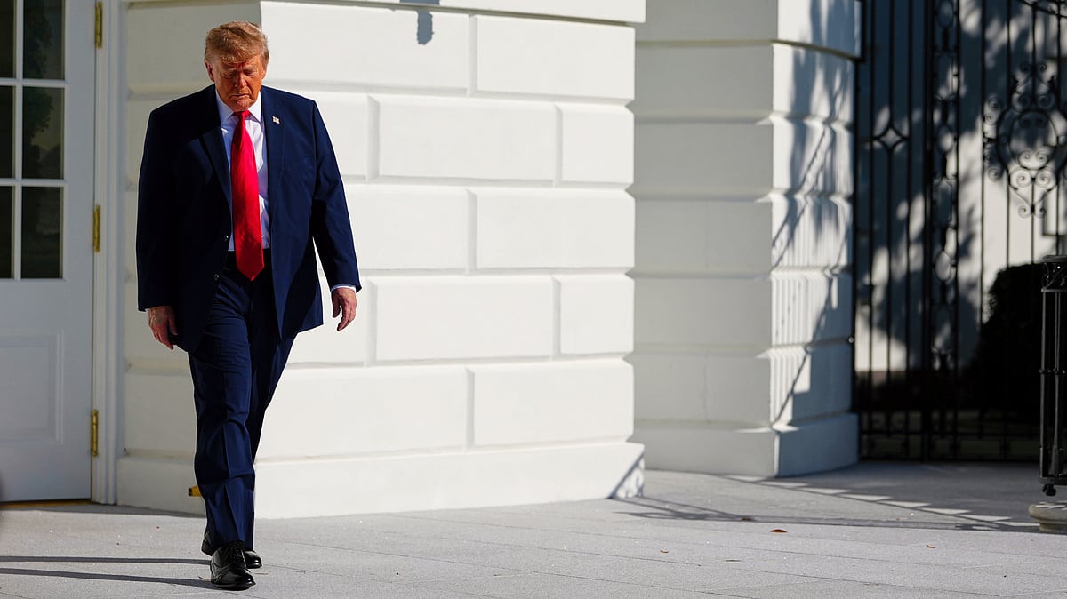 Donald Trump walks to speak with reporters on the South Lawn of the White House, 23 Oct