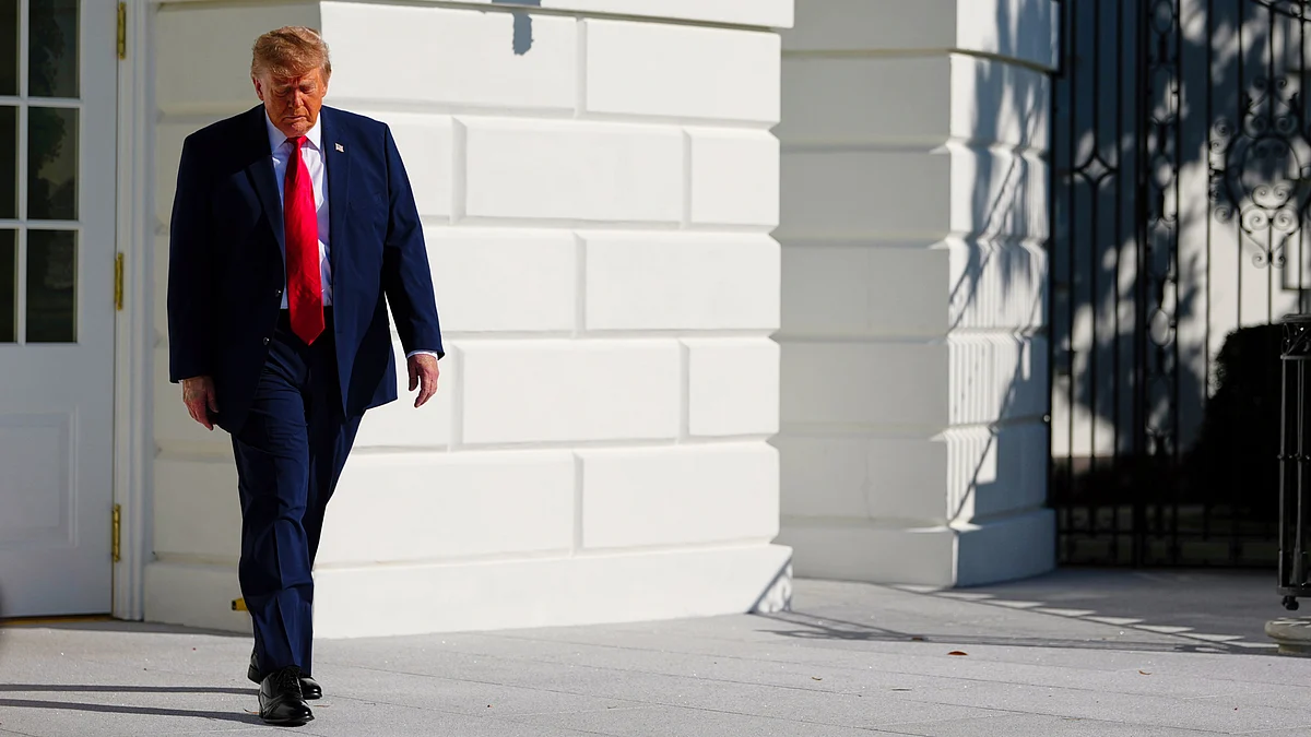 Donald Trump walks to speak with reporters on the South Lawn of the White House, 23 Oct
