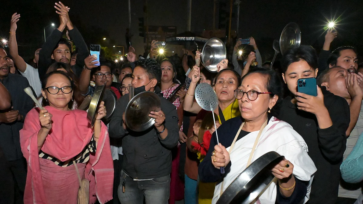 People bang utensils during a protest in Imphal.