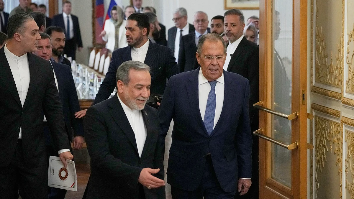 Abbas Araghchi (L) walks with Russian FM Sergey Lavrov during their meeting in Tehran.