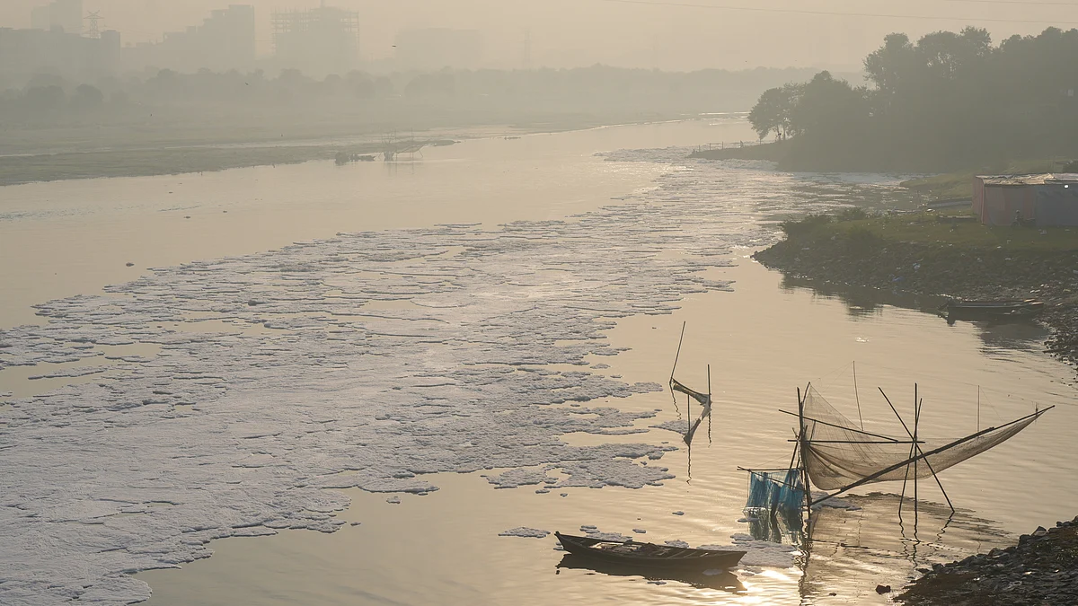 A thick layer of toxic foam covers Yamuna river surface amid haze in New Delhi.
