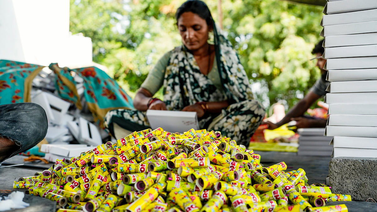A worker makes firecrackers ahead of Diwali at a factory unit in Ahmedabad, 19 Oct