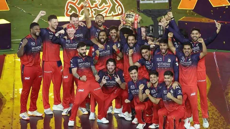 Royal Challengers Bengaluru celebrate with winners' trophy