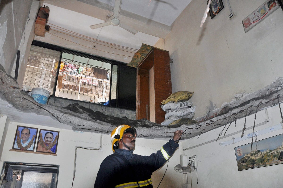 A fire brigade personnel inspects a portion of the 32-year-old Shreepal building after its first floor slab collapsed at Bhayender, in Mumbai