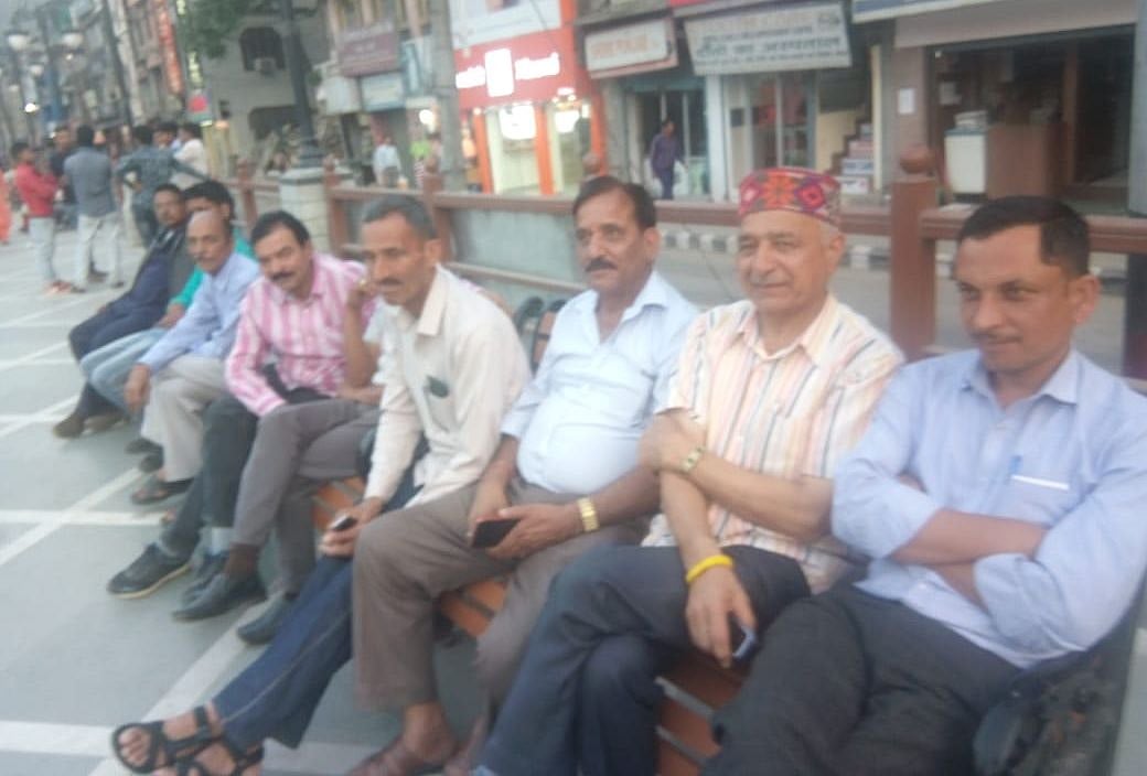 मंडी के इंद्रा मार्केट में बात करते हुए लोग