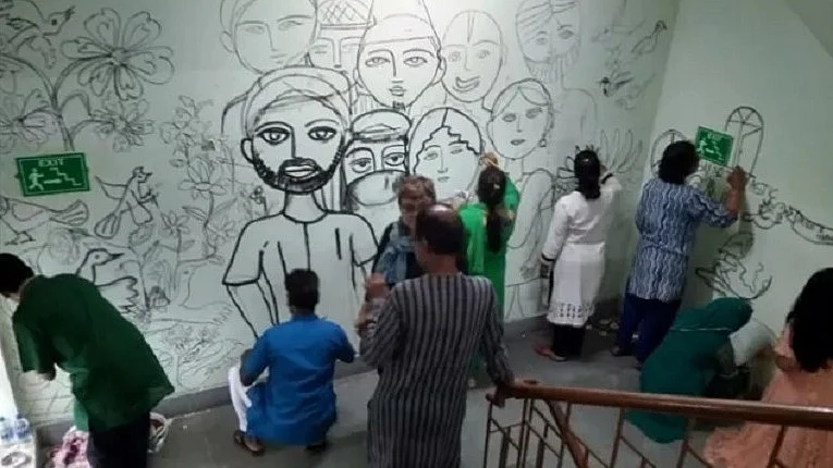 एकता की दीवार पर चित्रकारी करते आर्टिस्ट (तस्वीर कोलकाता की है)