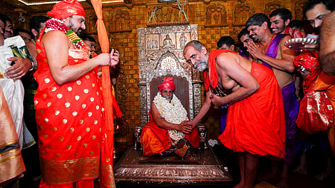 Sri Vishwapriya Theertha Swamiji of Sri Admar Matha handing over the reigns of Sri Krishna Matha to Sri Sugunendra Theertha Swamiji of Sri Puthige Matha on the occasion of latter's ascension to Paryaya Peeta in the wee hours on Thursday.