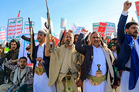 Supporters of Yemen's Huthis brandish rifles during a rally against Israel and the United States. 