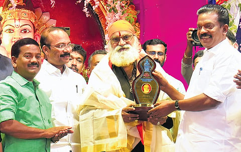 Devaswom Minister K Radhakrishnan presents this year’s ‘Harivarasanam’ award  to Tamil singer P K Veeramani Dasan at a function held at Sannidhanam auditorium in Sabarimala on Monday.  VETTIPURAM
