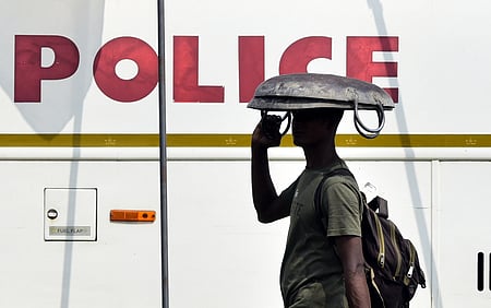 A migrant worker is using his iron tesla to escape from the heat of the scorching sun in Kochi on Sunday. 