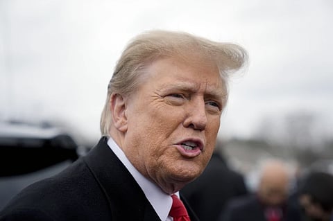 Donald Trump addresses members of the press during a campaign stop in Londonderry, N.H., on January 23, 2024.
