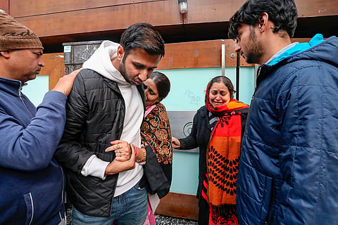 Relatives of victims of a fire that broke out at a house in Pitampura, in New Delhi, Friday, Jan. 19, 2024.