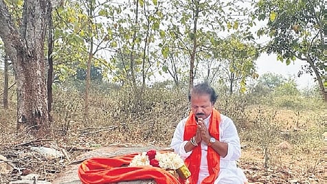 Sculptor Prakash Shilpi bows to a Krishna Shile stone.