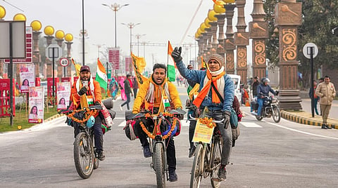 Devotees arrive on cycles ahead of the consecration ceremony of Ram Mandir, in Ayodhya.
