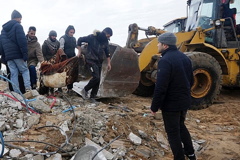 Palestinians collect bodies after an Israeli strike in Zuweida, Gaza Strip. 