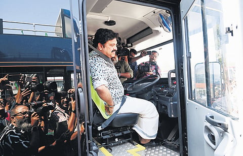 Transport Minister K B Ganesh Kumar behind the wheels of an electric double-decker bus of the KSRTC before a 
test drive in Thiruvananthapuram.