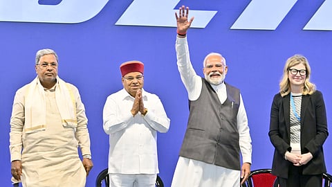 Prime Minister Narendra Modi waves to the gathering, while Boeing  COO Stephanie Pope looks on, in Bengaluru.