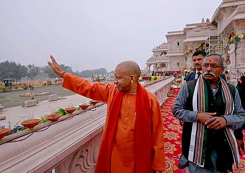 UP Chief Minister Yogi Adityanath waves from the premises of the Ram Mandir ahead of its consecration ceremony 